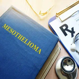 Mesothelioma book, stethoscope, and clipboard with prescription on a table - Mesothelioma Claims